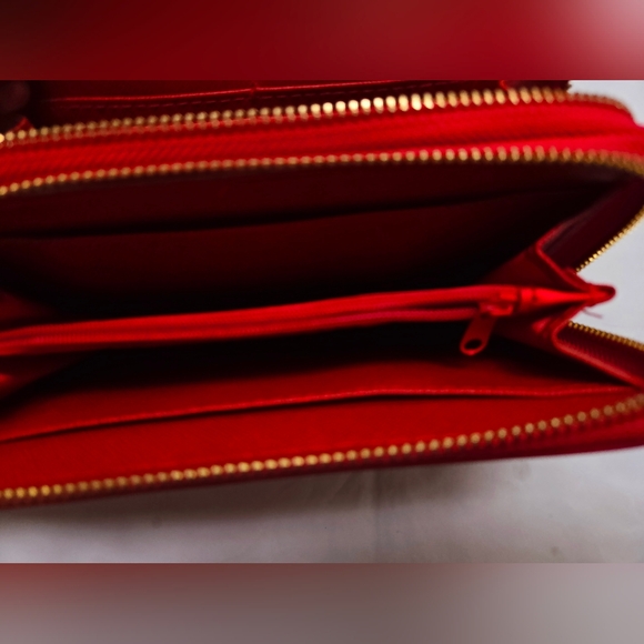Red wallet with 2 zipper compartments and a wrist handle. - Picture 3 of 12